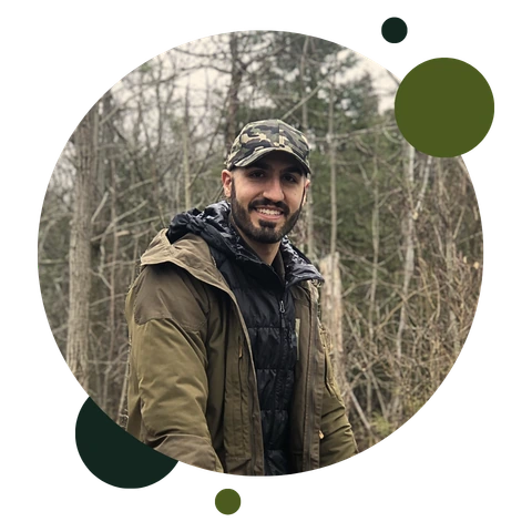 About Robert Valela 2 Robert Valela, Psychologist and Therapist Smiling into the Camera while standing outside in a forest.